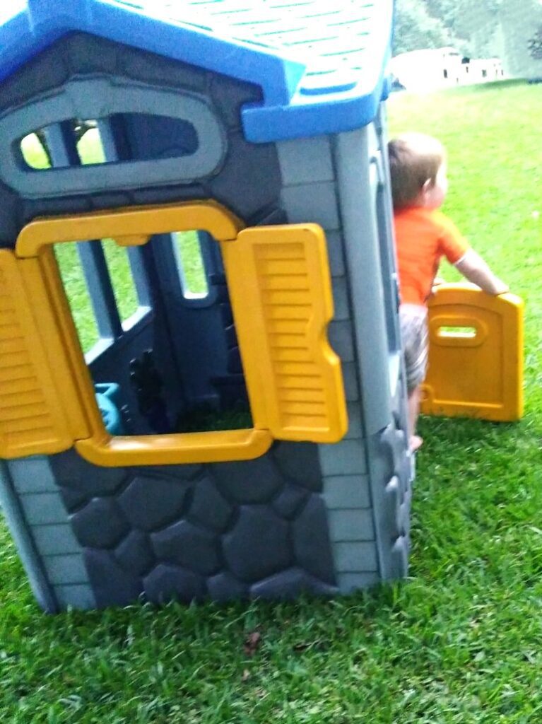 child playing with finished playhouse