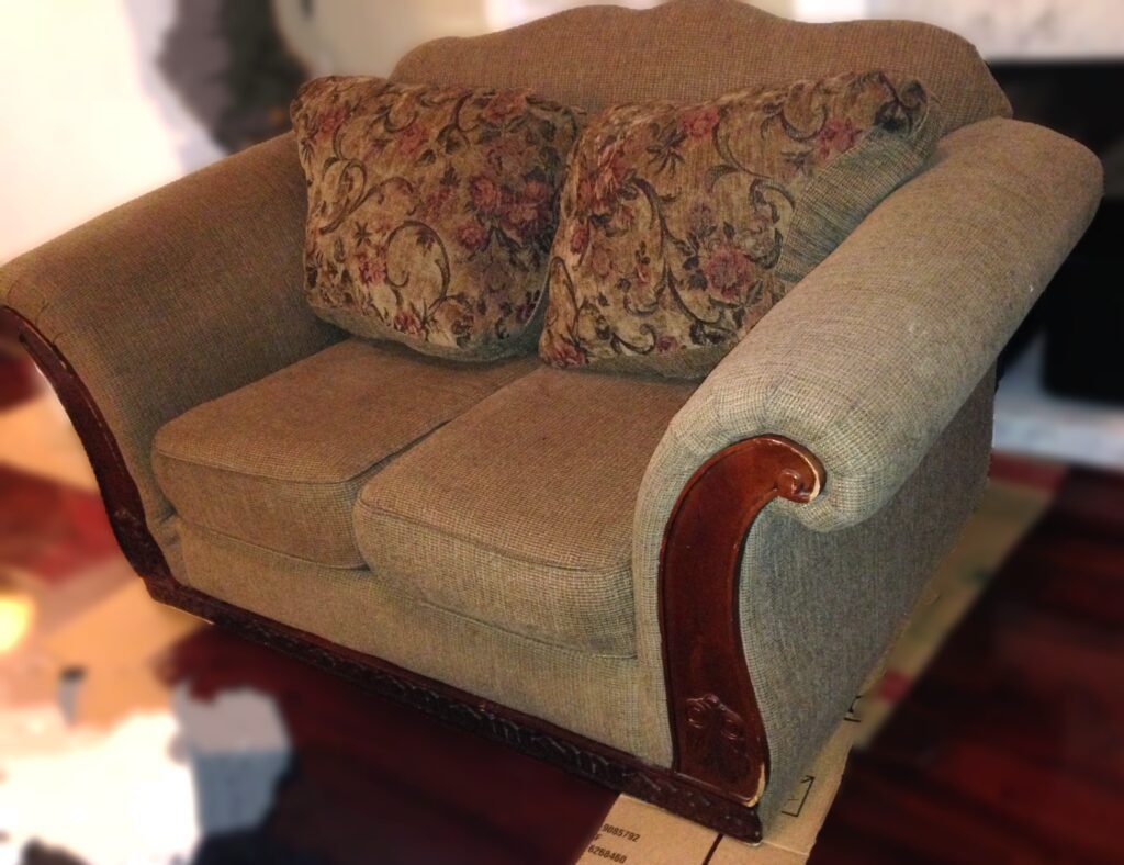 original loveseat with detail of wooden trim attached